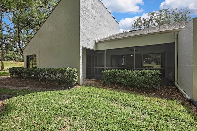 4175 Northmeadow Cir Unit 4175, Tampa, FL 33618 - view of side of property featuring a yard, a sunroom, and stucco siding