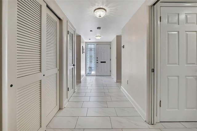 4175 Northmeadow Cir Unit 4175, Tampa, FL 33618 - hallway featuring baseboards and light marble finish flooring