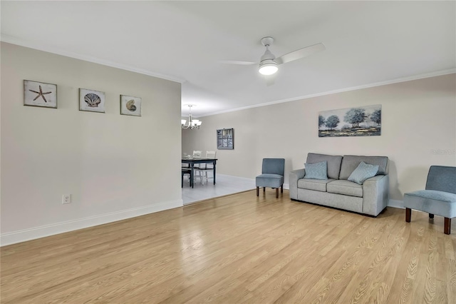 4175 Northmeadow Cir Unit 4175, Tampa, FL 33618 - living room featuring a chandelier, crown molding, light wood-type flooring, ceiling fan, and baseboards