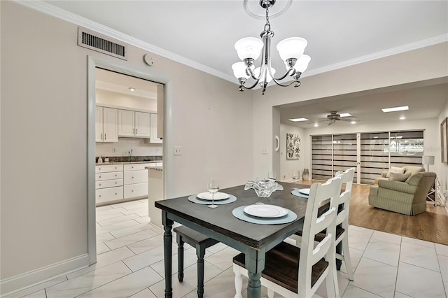 4175 Northmeadow Cir Unit 4175, Tampa, FL 33618 - dining space featuring crown molding, a chandelier, ceiling fan, and baseboards