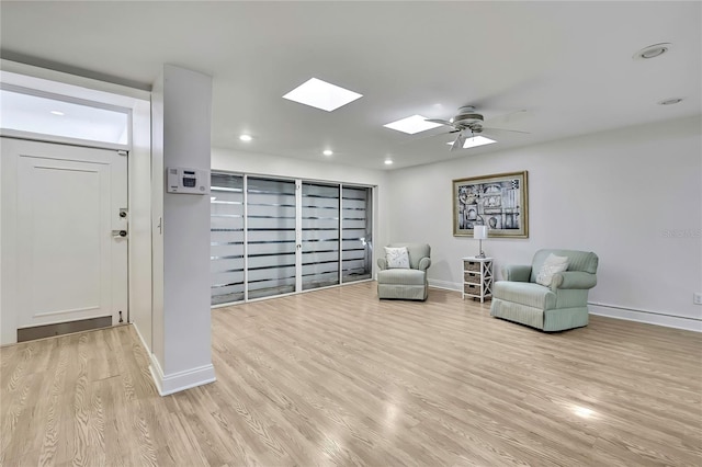 4175 Northmeadow Cir Unit 4175, Tampa, FL 33618 - sitting room featuring a skylight, baseboards, light wood-style flooring, ceiling fan, and recessed lighting