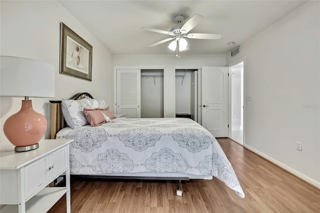 4175 Northmeadow Cir Unit 4175, Tampa, FL 33618 - bedroom with two closets, wood finished floors, baseboards, and a ceiling fan