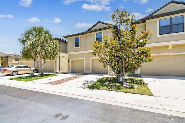 view of front of property featuring an attached garage, stucco siding, and driveway