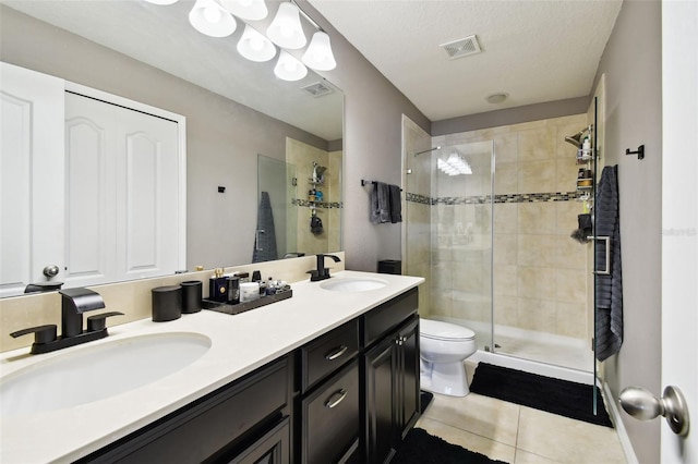 bathroom featuring tile patterned floors, visible vents, a sink, and a stall shower