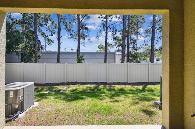 view of yard featuring central air condition unit and a fenced backyard