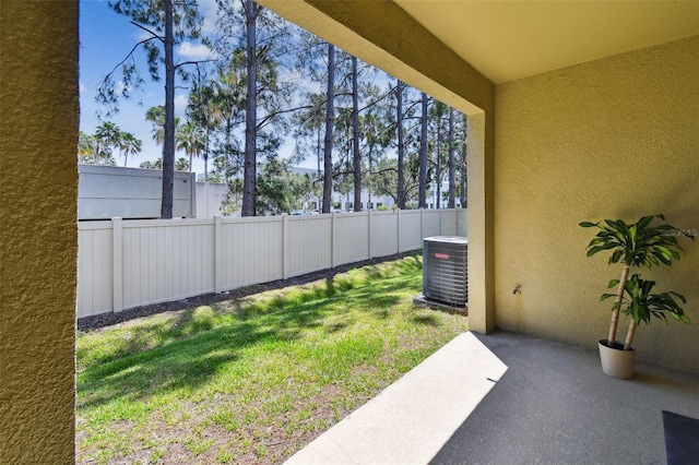 view of yard with central air condition unit, fence, and a patio