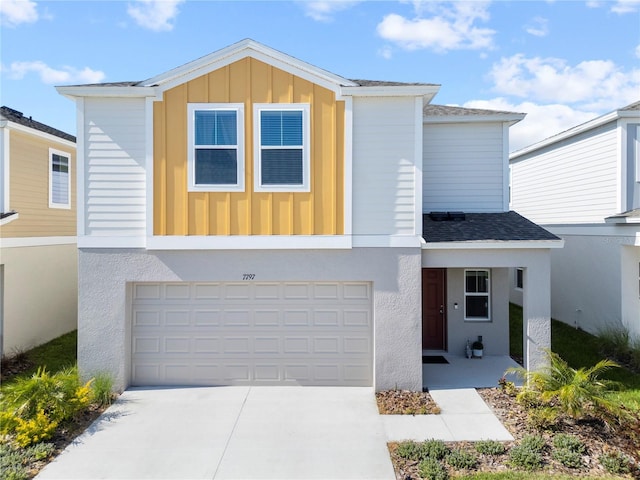 7797 Peace Lily Ave, Wesley Chapel, FL 33545 - view of front of property with roof with shingles, board and batten siding, an attached garage, and concrete driveway
