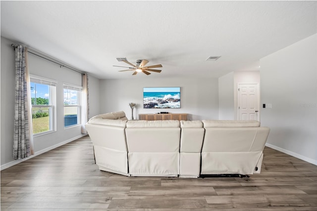 7797 Peace Lily Ave, Wesley Chapel, FL 33545 - living room featuring baseboards, visible vents, wood finished floors, and ceiling fan