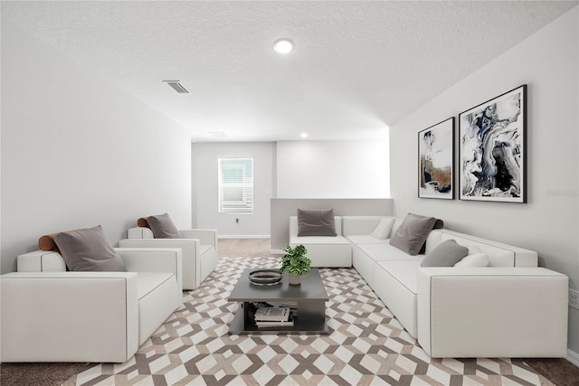7797 Peace Lily Ave, Wesley Chapel, FL 33545 - living area with a textured ceiling, visible vents, light colored carpet, and baseboards