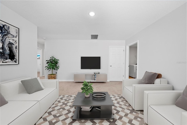 7797 Peace Lily Ave, Wesley Chapel, FL 33545 - living room with baseboards, visible vents, washer / clothes dryer, and light carpet
