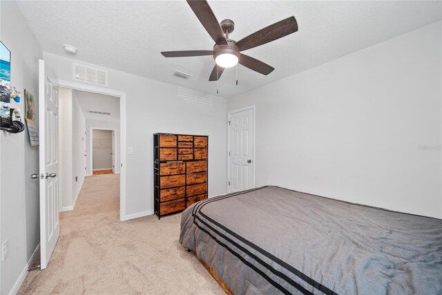 7797 Peace Lily Ave, Wesley Chapel, FL 33545 - bedroom featuring a ceiling fan, visible vents, light carpet, and baseboards