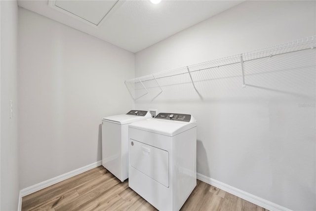 7797 Peace Lily Ave, Wesley Chapel, FL 33545 - clothes washing area with baseboards, light wood-type flooring, laundry area, and independent washer and dryer