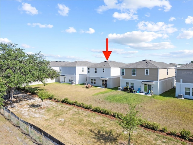 7797 Peace Lily Ave, Wesley Chapel, FL 33545 - rear view of property featuring fence private yard, stucco siding, a yard, and central air condition unit