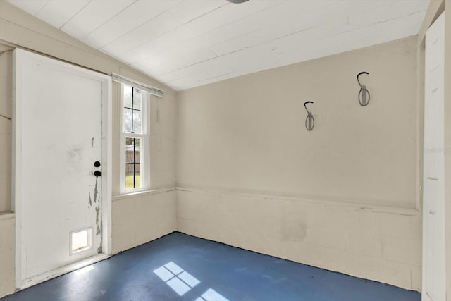 entryway featuring concrete floors, plenty of natural light, and lofted ceiling