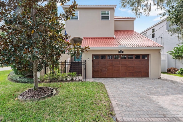 2701 W Bay Ave, Tampa, FL 33611 - mediterranean / spanish-style home featuring a tiled roof, driveway, fence, an attached garage, and stucco siding
