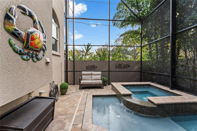 2701 W Bay Ave, Tampa, FL 33611 - view of swimming pool with glass enclosure, a pool with connected hot tub, and a patio area