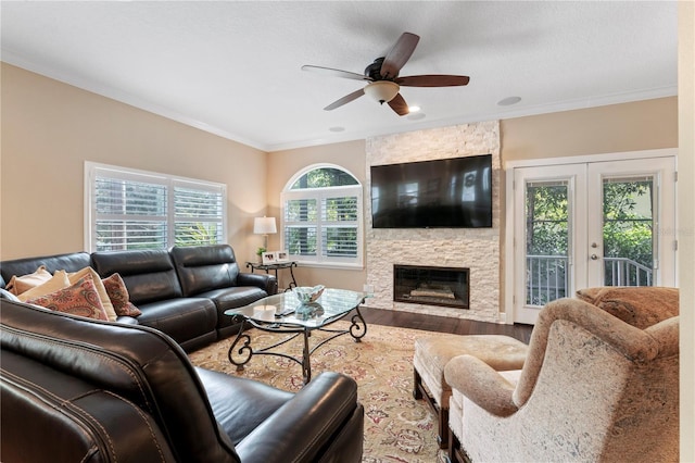 2701 W Bay Ave, Tampa, FL 33611 - living area featuring ornamental molding, wood finished floors, a stone fireplace, french doors, and a ceiling fan