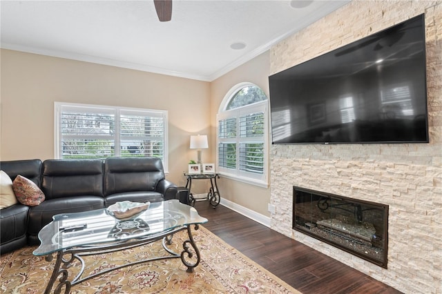 2701 W Bay Ave, Tampa, FL 33611 - living area featuring crown molding, a stone fireplace, a ceiling fan, baseboards, and dark wood-type flooring