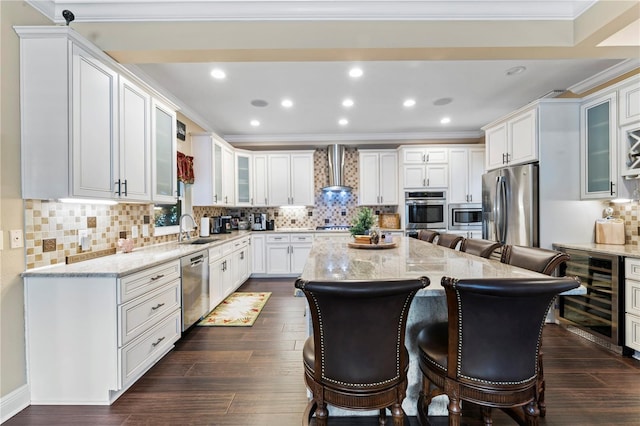 2701 W Bay Ave, Tampa, FL 33611 - kitchen with light stone countertops, beverage cooler, a kitchen bar, a sink, and appliances with stainless steel finishes