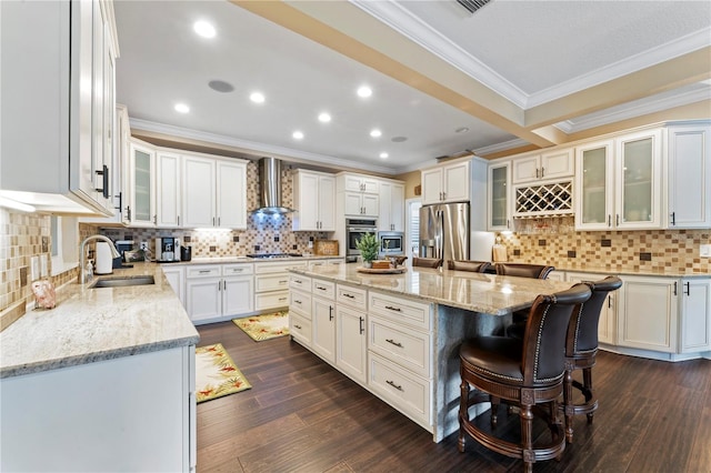 2701 W Bay Ave, Tampa, FL 33611 - kitchen featuring wall chimney range hood, appliances with stainless steel finishes, a sink, a center island, and ornamental molding