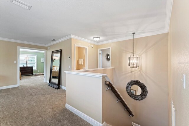 2701 W Bay Ave, Tampa, FL 33611 - hall featuring visible vents, crown molding, baseboards, an upstairs landing, and carpet flooring