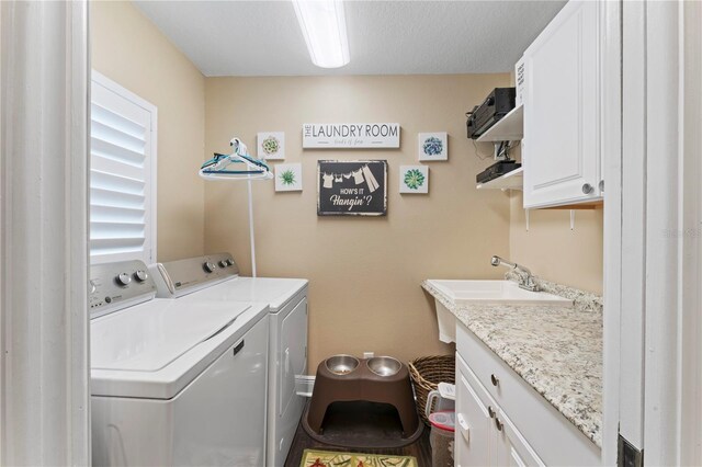 2701 W Bay Ave, Tampa, FL 33611 - laundry room featuring a sink, cabinet space, and washing machine and clothes dryer