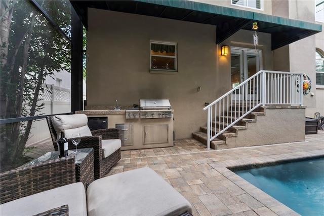 2701 W Bay Ave, Tampa, FL 33611 - exterior space featuring area for grilling, an outdoor pool, a patio area, a sink, and stucco siding