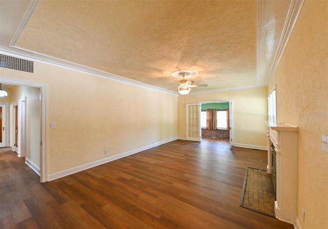 unfurnished room featuring visible vents, baseboards, a textured ceiling, a ceiling fan, and dark wood finished floors