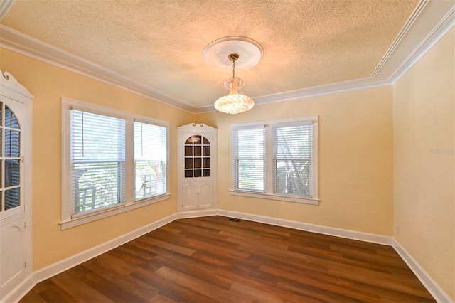 unfurnished dining area with dark wood finished floors, ornamental molding, a textured ceiling, and a chandelier