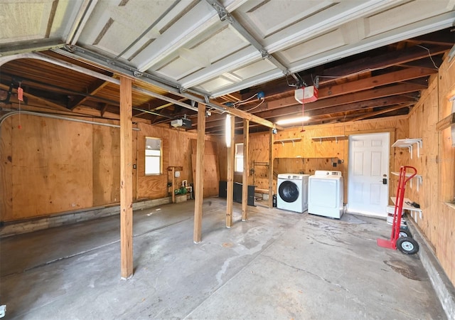 below grade area featuring wooden walls and washer and clothes dryer
