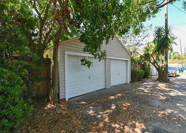 detached garage featuring fence