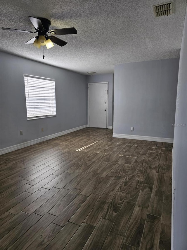 4043 La Pasida Ln, New Port Richey, FL 34655 - unfurnished room featuring a textured ceiling, visible vents, baseboards, and dark wood finished floors
