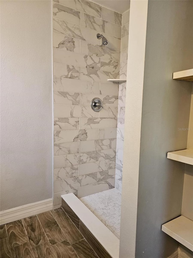 4043 La Pasida Ln, New Port Richey, FL 34655 - bathroom with baseboards, a tile shower, and marble finish floor