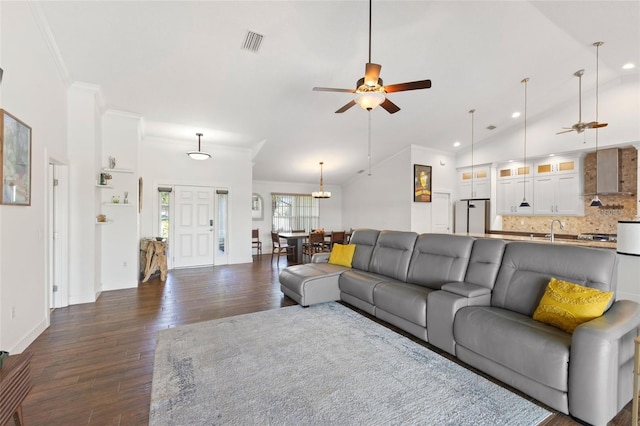 living area with recessed lighting, ceiling fan, ornamental molding, and dark wood finished floors