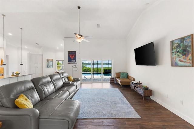 living room with a ceiling fan, baseboards, dark wood-style floors, lofted ceiling, and ornamental molding