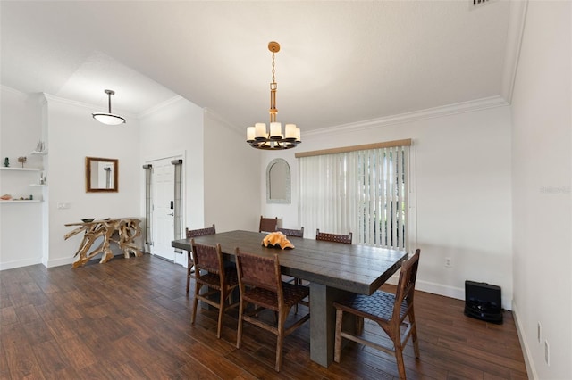 dining area featuring dark wood-type flooring, ornamental molding, baseboards, and a chandelier