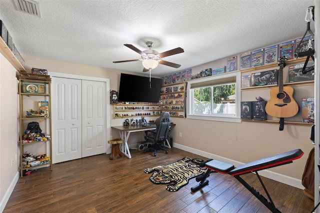 office with a ceiling fan, baseboards, and a textured ceiling