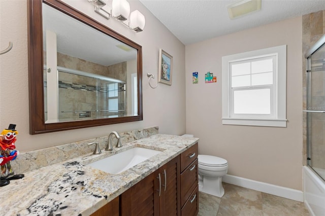 bathroom with baseboards, vanity, and toilet