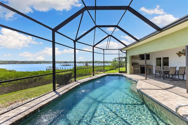 pool with grilling area, exterior kitchen, a patio, and glass enclosure