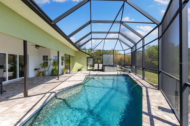 outdoor pool with ceiling fan, a patio area, and a lanai
