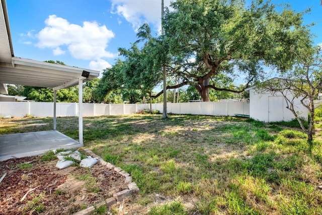 4310 S Coolidge Ave, Tampa, FL 33611 - view of yard featuring a fenced backyard, an outbuilding, a patio area, and a shed