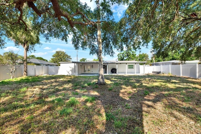 4310 S Coolidge Ave, Tampa, FL 33611 - back of property with a lawn, a patio, and a fenced backyard