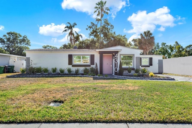4310 S Coolidge Ave, Tampa, FL 33611 - ranch-style house with fence, stucco siding, and a front lawn