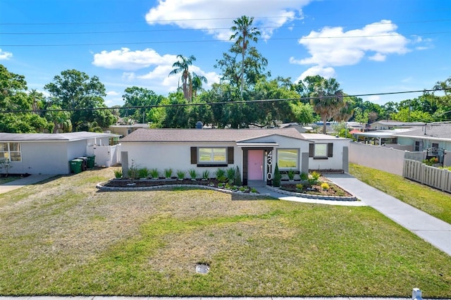 4310 S Coolidge Ave, Tampa, FL 33611 - ranch-style home featuring stucco siding, fence, and a front yard
