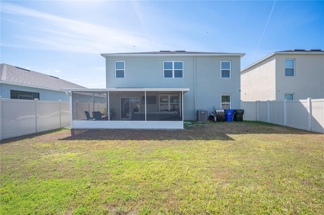 rear view of property featuring a fenced backyard, stucco siding, a sunroom, central AC unit, and a yard