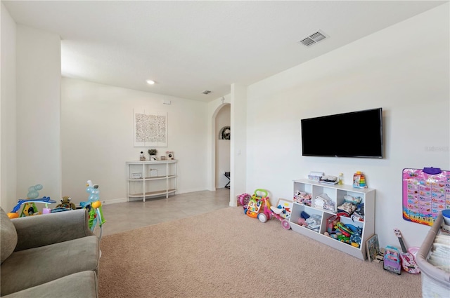 playroom featuring arched walkways, tile patterned floors, recessed lighting, baseboards, and visible vents