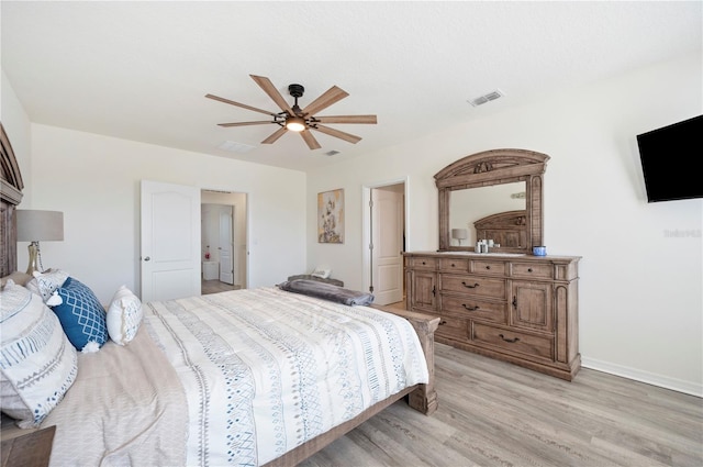 bedroom with light wood-type flooring, baseboards, ceiling fan, and visible vents