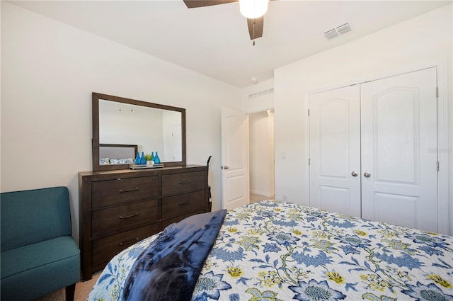 carpeted bedroom featuring visible vents, ceiling fan, and a closet