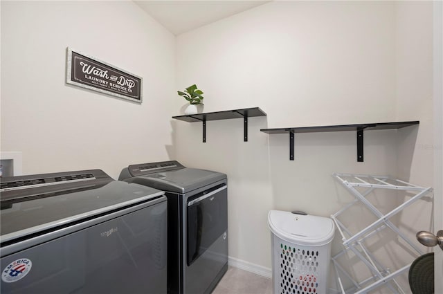 washroom with laundry area, baseboards, light tile patterned flooring, and separate washer and dryer