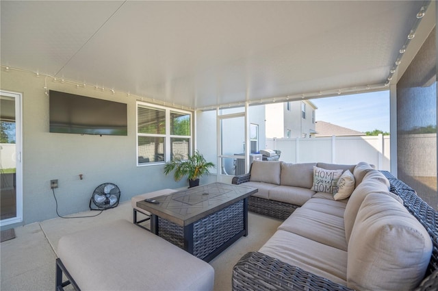 sunroom featuring plenty of natural light and an outdoor living space